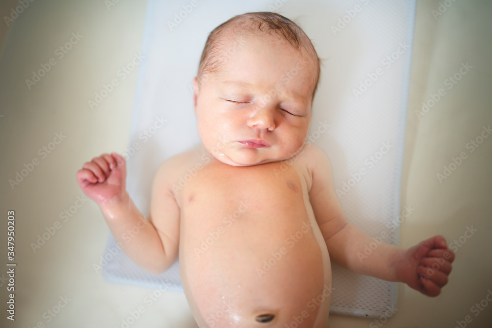 A friendly newborn baby-girl in bath A friendly newborn baby-girl in bath