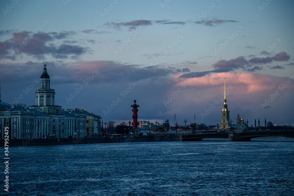 View of the embankment and the Palace Bridge at a beautiful sunset. Saint-Petersburg, Russia.