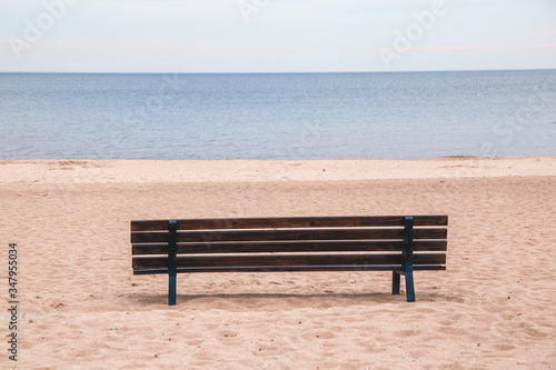 Lonely bench on the sandy seashore. Without people.