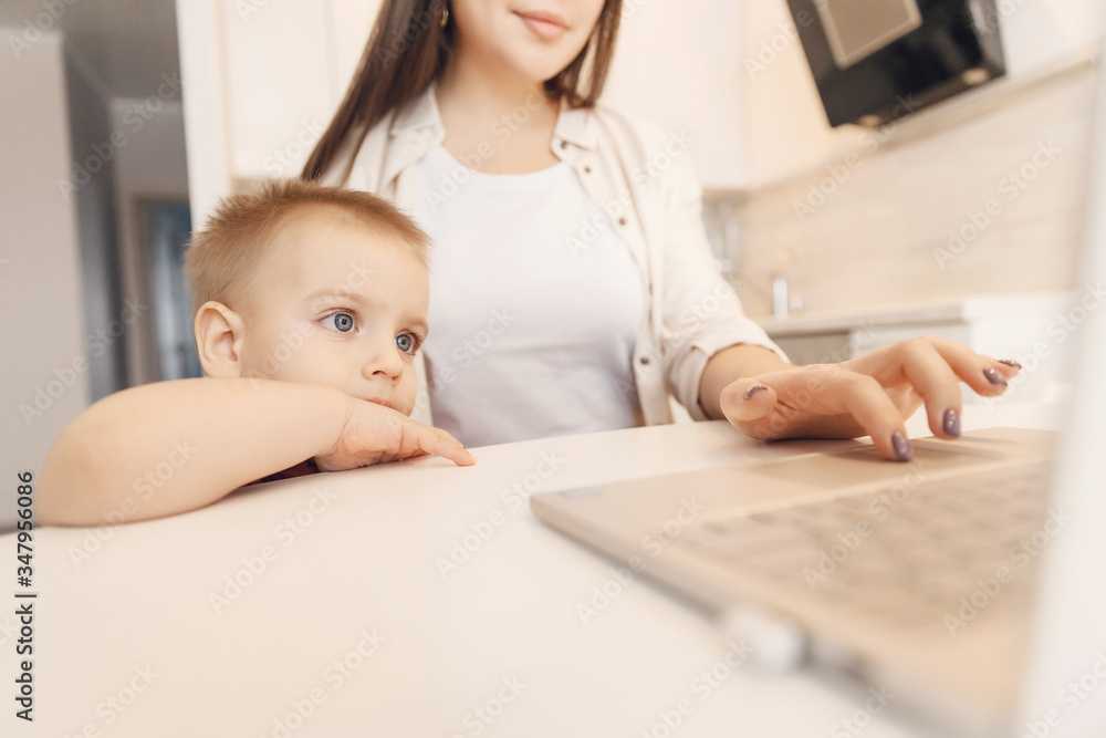 Businesswoman mother woman with small child son working online computer home office Businesswoman mother woman with small child son working online computer home office