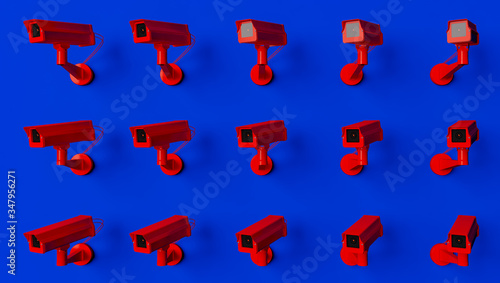 Red surveillance camera on blue background monitoring people on the street. Camera to search for quarantine offenders caused by Coronavirus photo