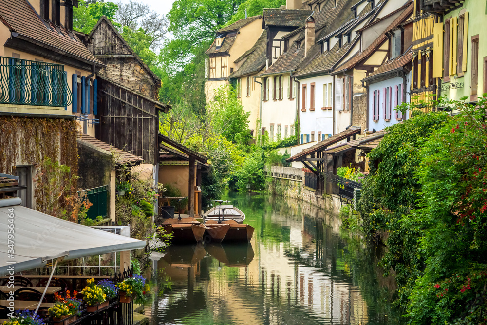 Traditional french houses and old boats on the side of river Lauch in Petite Venise, Colmar, France