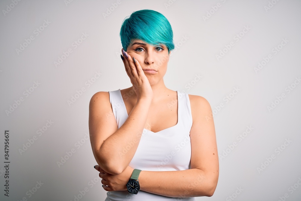 Young beautiful woman with blue fashion hair wearing casual t-shirt over white background thinking looking tired and bored with depression problems with crossed arms. Young beautiful woman with blue fashion hair wearing casual t-shirt over white background thinking looking tired and bored with depression problems with crossed arms.