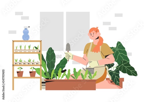 Woman on a balcony or patio growing plants or vegetables in a flowerpot, planting and watering seeds. Concept of urban home gardening or indoor vegitables farming. Seedling in a paper containers.