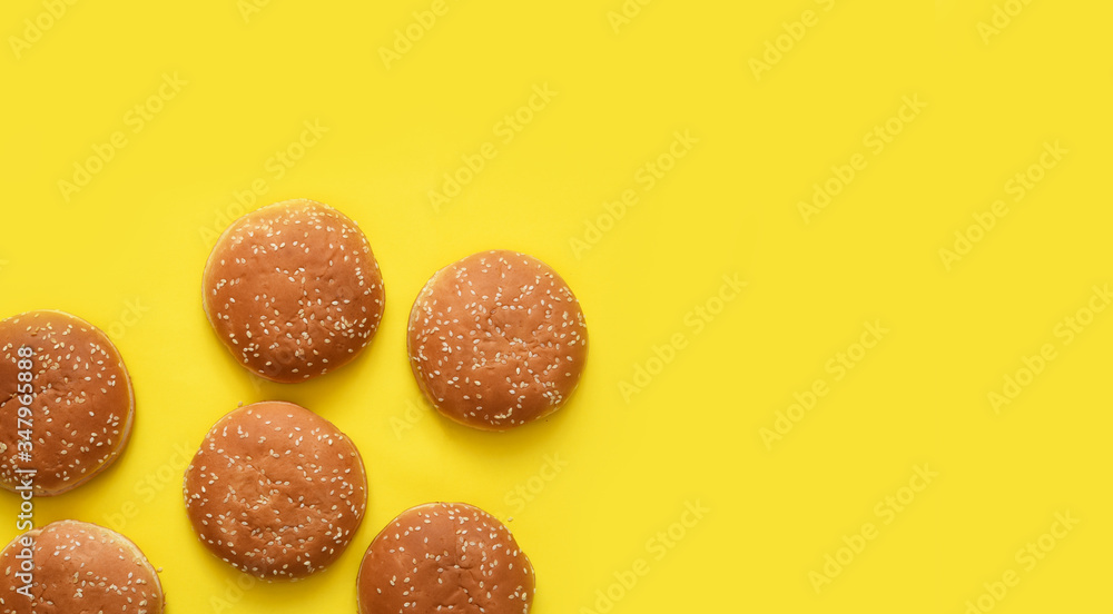 Hamburger bun on a yellow background. Fast food. Hamburger bun on a yellow background. Fast food.