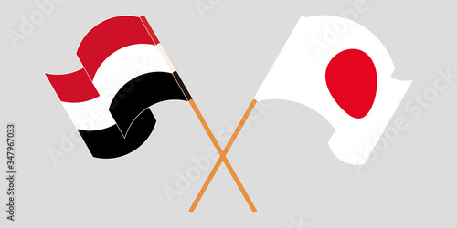 Crossed and waving flags of Yemen and Japan