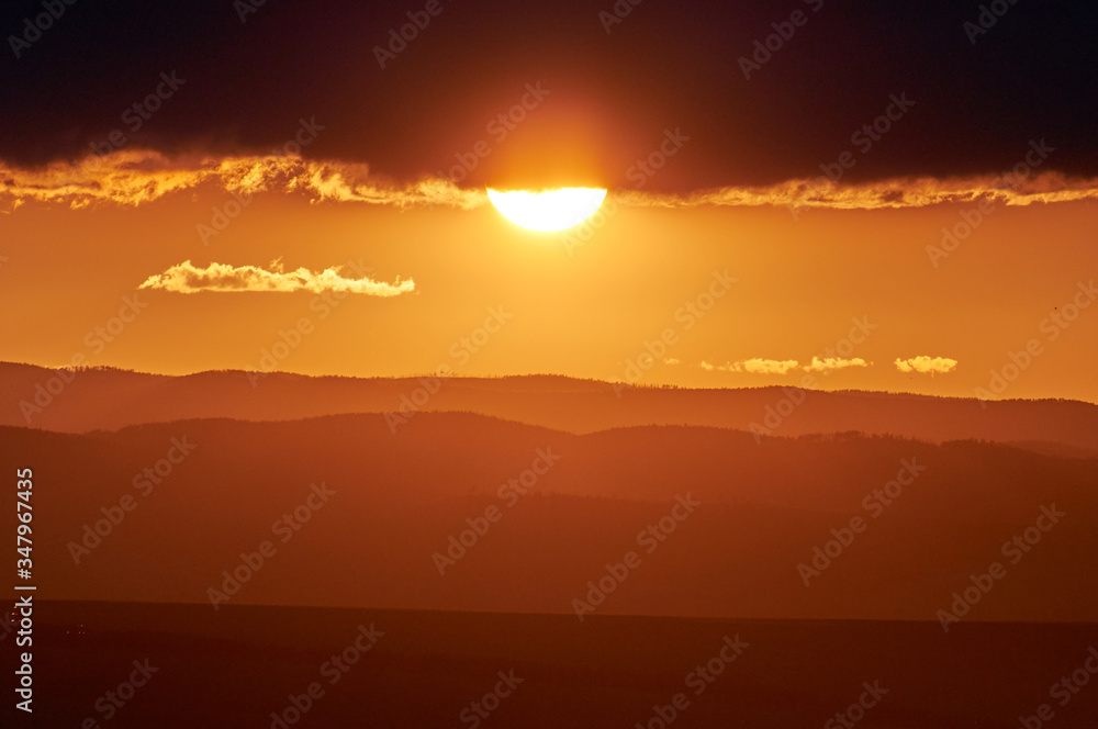 Rain over the distant hills at sunset. Zabaykalsky Krai. Russia. Rain over the distant hills at sunset. Zabaykalsky Krai. Russia.