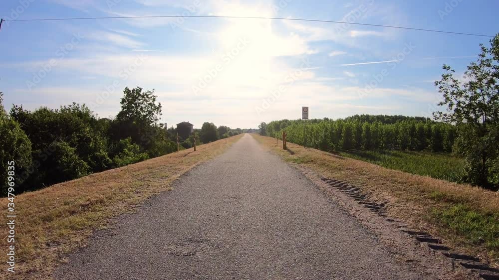 a country road on the Embankment along the Po river next to San Zenone al Po, province of Pavia, Lombardy, Italy a country road on the Embankment along the Po river next to San Zenone al Po, province of Pavia, Lombardy, Italy