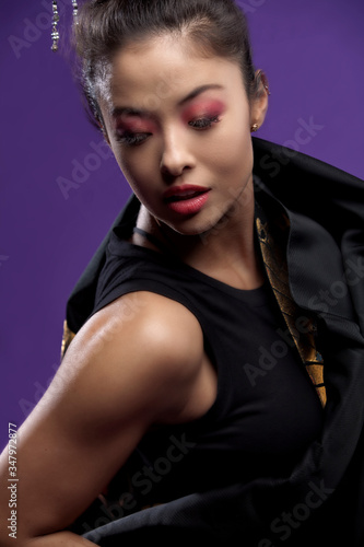 portrait of an Asian woman Japanese fashion beauty model is wearing red lip stick and shadows with a matching kimono poses in a isolated studio background