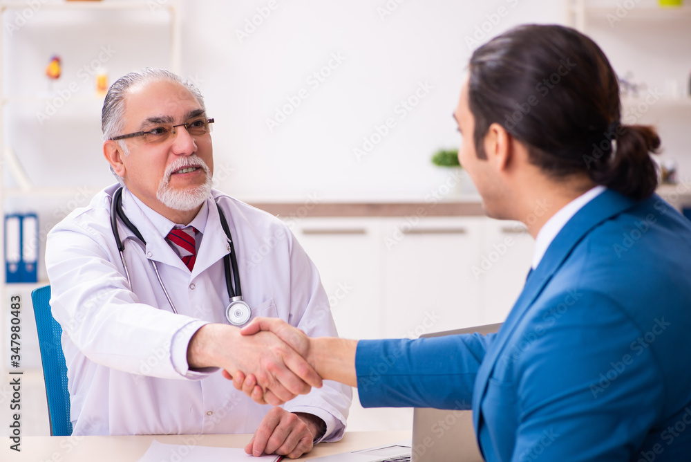 Young businessman meeting with old doctor Young businessman meeting with old doctor