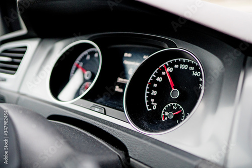 Electronic speed dashboard inside of modern car. © M-Production