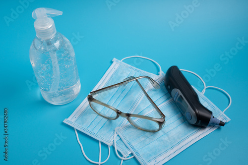 Face mask, thermometer , sanitizer gel and glasses. Corona virus concept.