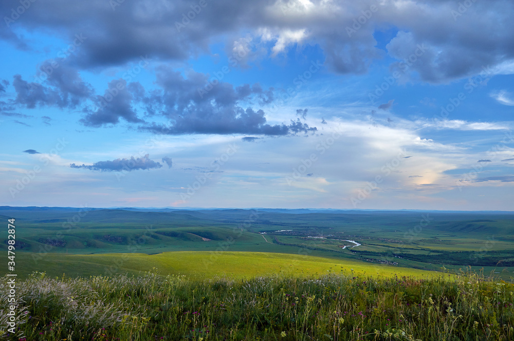 Steppes and distant green hills in the rain. Zabaykalsky Krai. Russia.