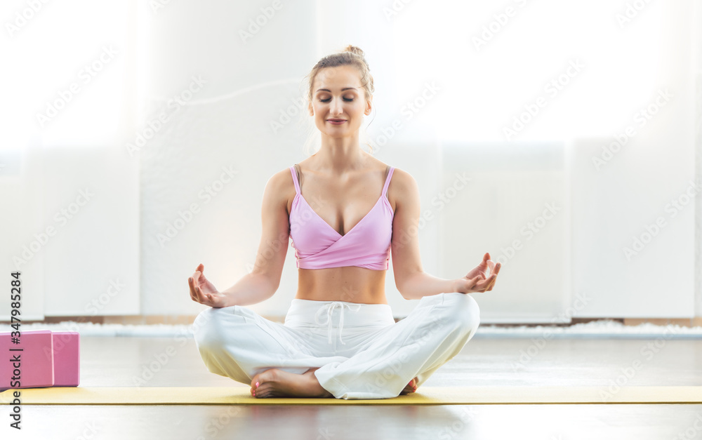 Beautiful woman meditating in yoga pose Beautiful woman meditating in yoga pose