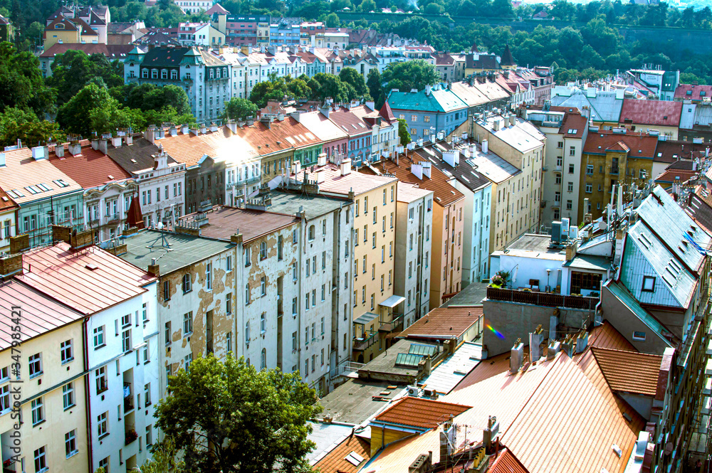 Fototapeta premium Ancient houses, street and many green trees top view