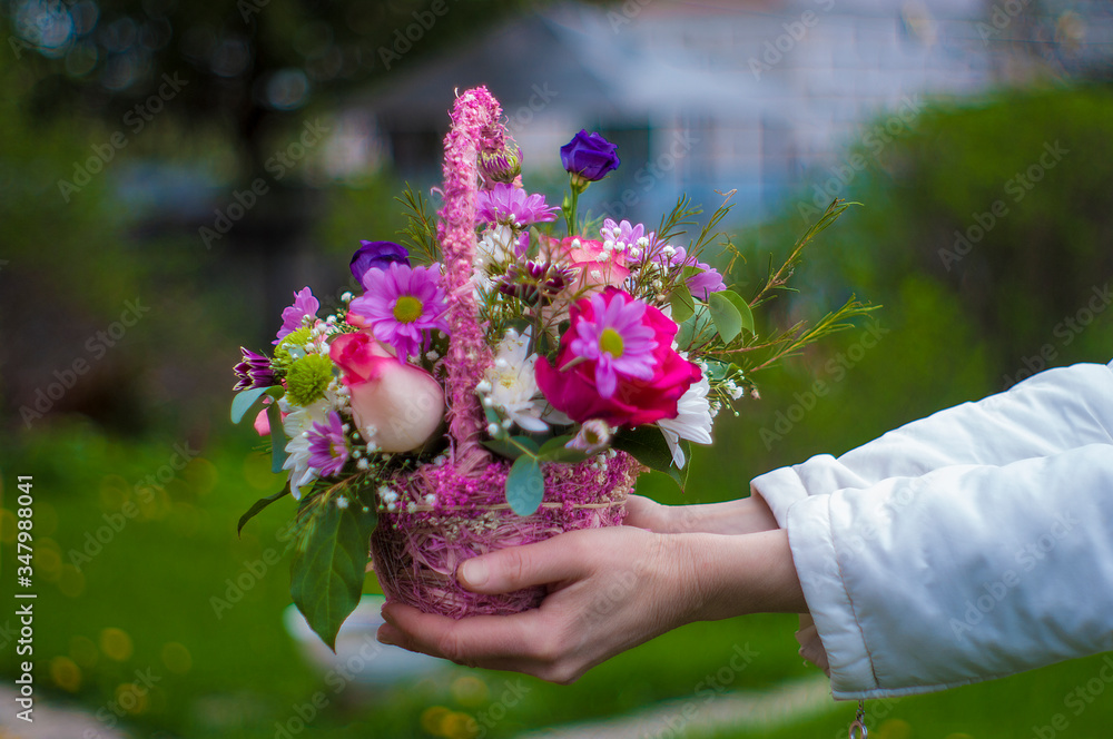 basket with flowers in the hands of a girl basket with flowers in the hands of a girl