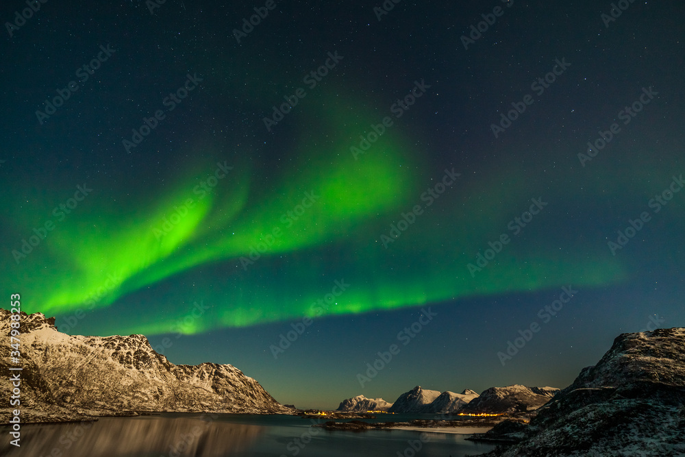 Amazing northern lights, Aurora borealis over the mountains in the North of Europe - Lofoten islands, Norway