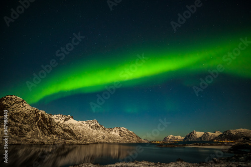 Nature of Norway, amazing northern lights, aurora borealis over the mountains in the North of Europe - Lofoten islands, Norway © Tatiana