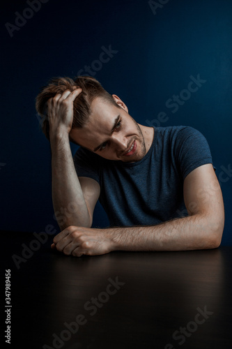 depressed guy holds hair