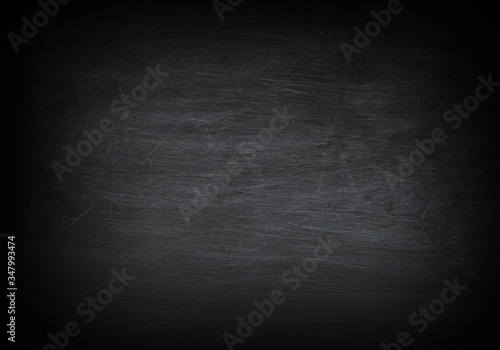 Dark, grunge and scratched black texture may used as background