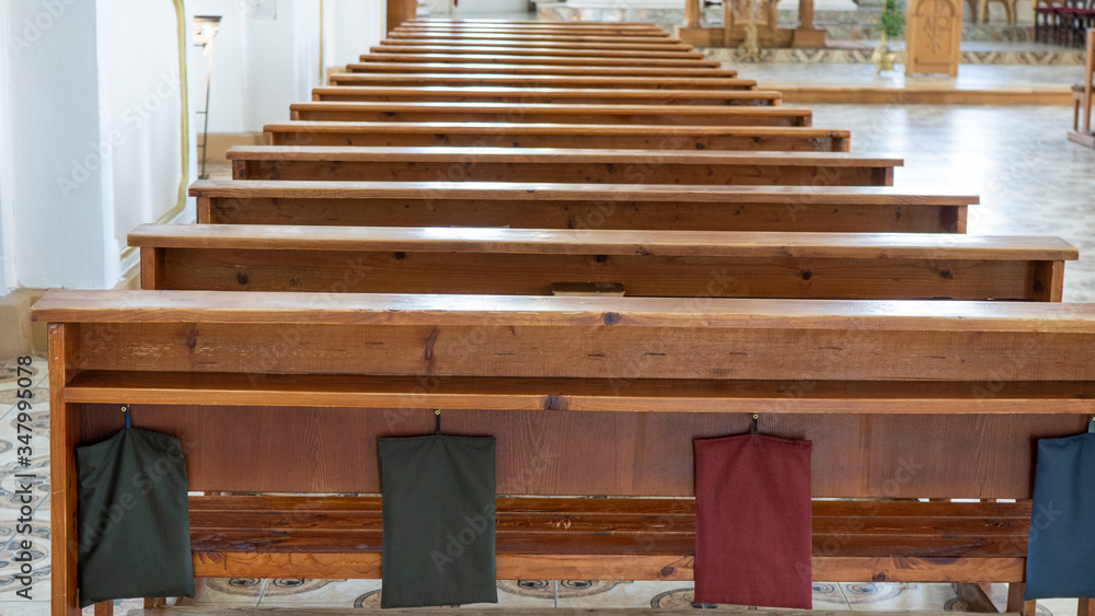 Wooden Benches in Catholic Church. Catholic Temple Seats, Blurred Background. Religious Background. Divine Light, Grace, Hope Concept.