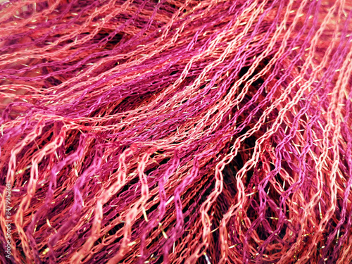 Background of bright pink and gold threads