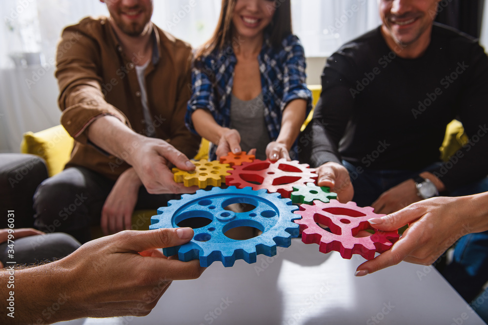 Business team connect pieces of gears. Teamwork, partnership and integration concept Business team connect pieces of gears. Teamwork, partnership and integration concept