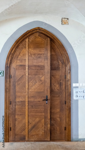 Ancient Gothic Church Portal Carved Wooden Door Church. Large Brown Antique Style Doors Full Frame. Historic Entrance of a Church