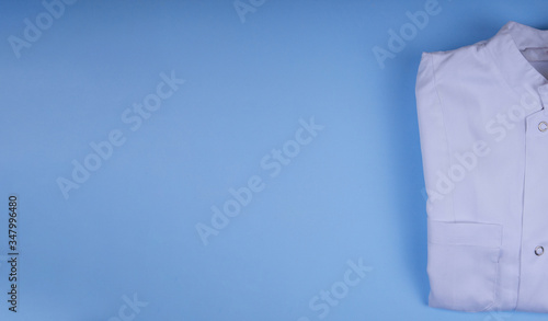 white medical dressing gown on blue background