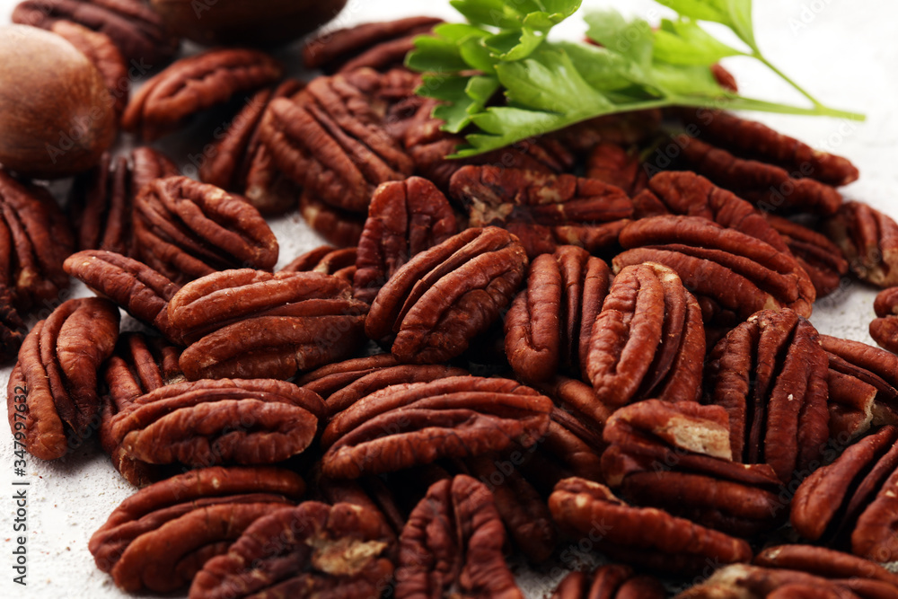 Tasty Pecan nuts on a rustic table. Tasty Pecan nuts on a rustic table.
