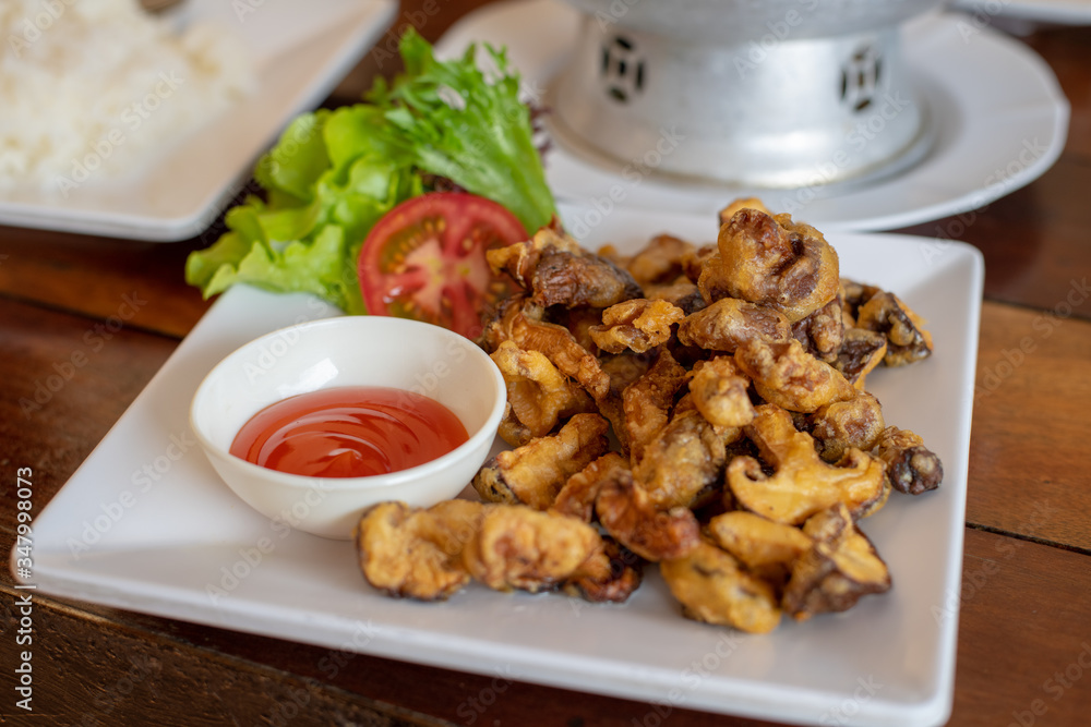 Fried shiitake mushrooms served on a white plate with chilli sauce Fried shiitake mushrooms served on a white plate with chilli sauce