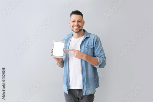 Handsome man with tablet co...