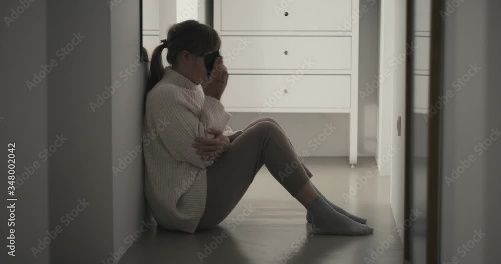 Woman is a victim of domestic violence physical abuse full of bruises end call for help and cry during quarantine confinement coronavirus covid 19 pandemic