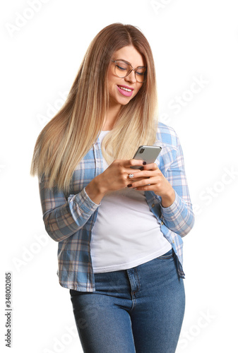 Portrait of beautiful young woman with mobile phone on white background