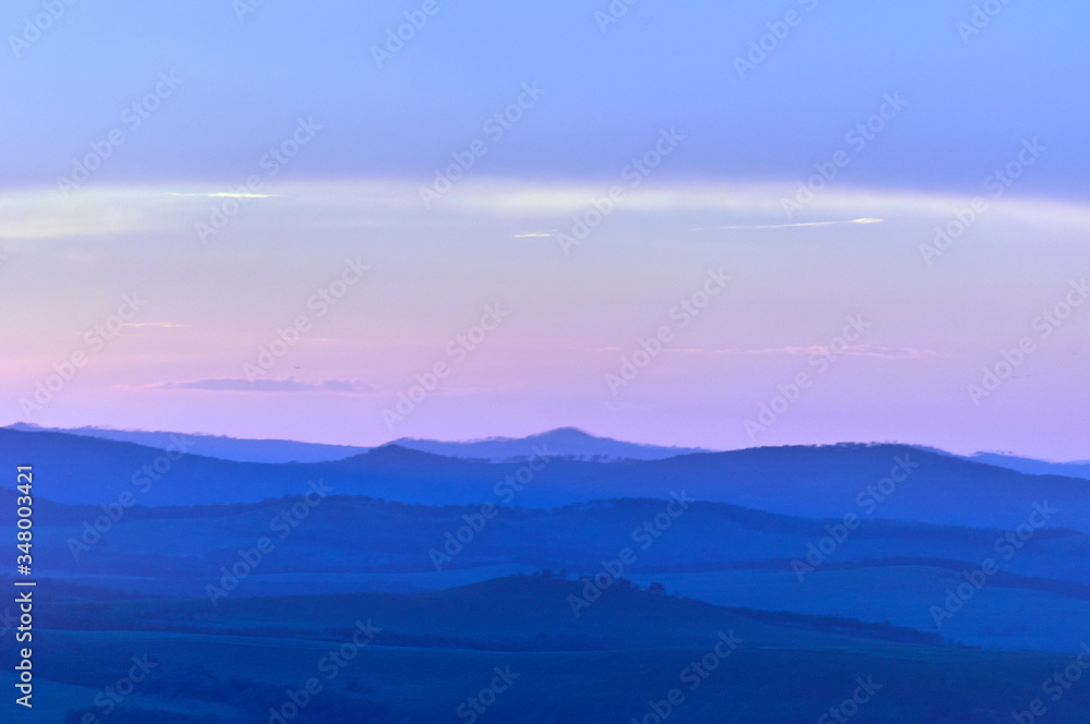 Distant hills over the steppe at sunset. Zabaykalsky Krai. Russia.