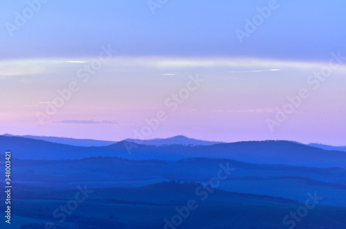 Distant hills over the steppe at sunset. Zabaykalsky Krai. Russia.