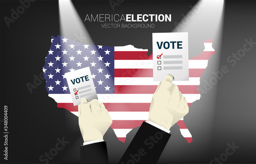 close up businessman hand with ballot paper for election with America flag in map. concept for USA election vote theme background.