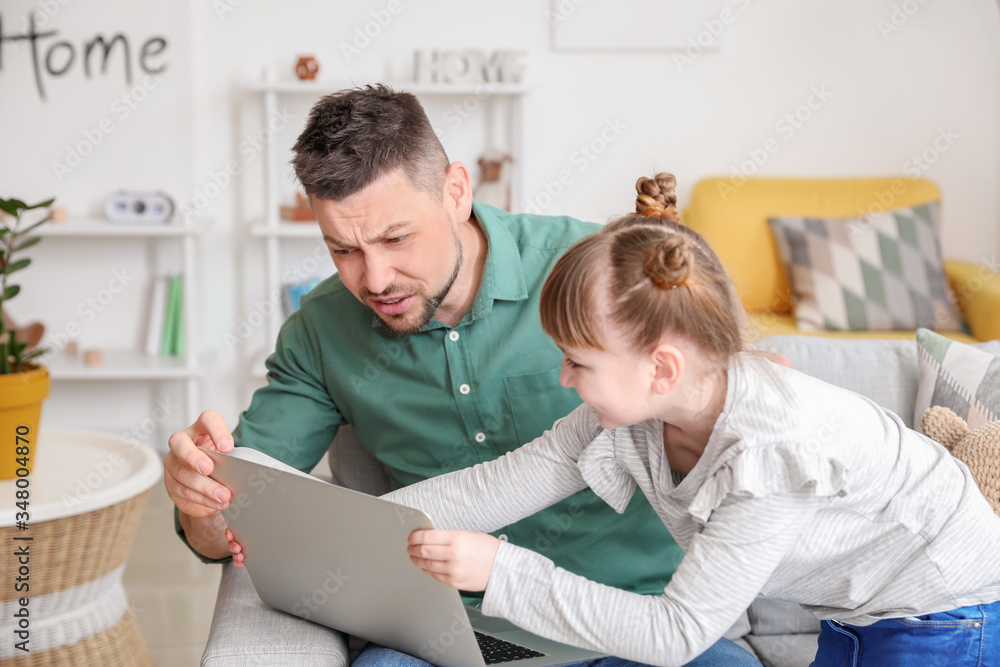 Little daughter keeping father from his work at home Little daughter keeping father from his work at home
