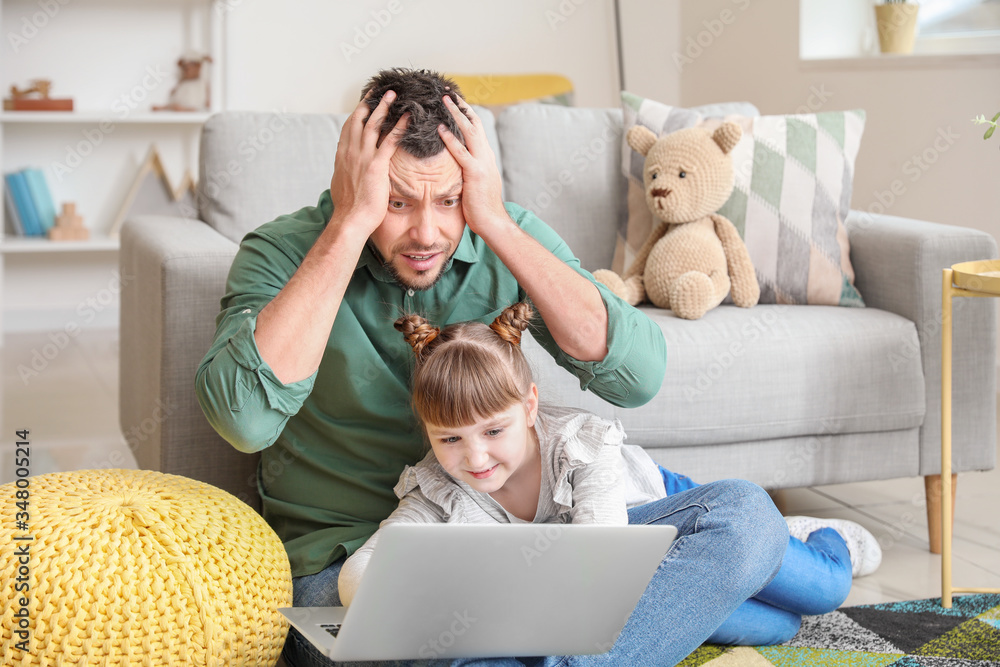 Little daughter keeping father from his work at home Little daughter keeping father from his work at home