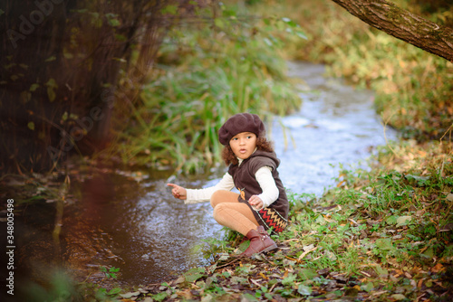 Fototapeta Naklejka Na Ścianę i Meble -  Happy Little Girl playing in the river.