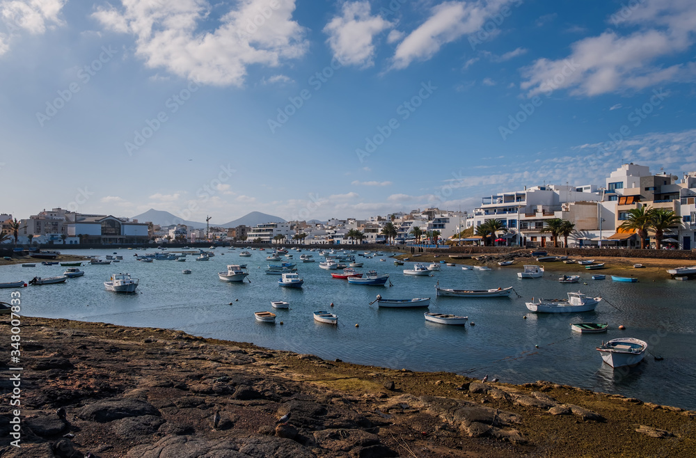 Fisher boats at the laguna Charco de San Gines at sunset, city of Arrecife, Lanzarote, Canary Islands. October 2019