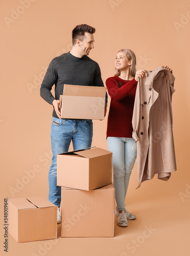Young couple unpacking clot...