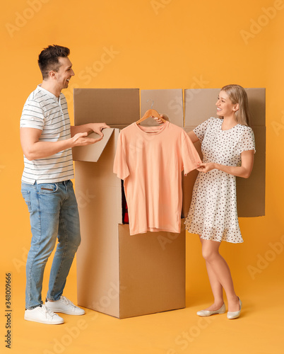 Young couple unpacking clot...