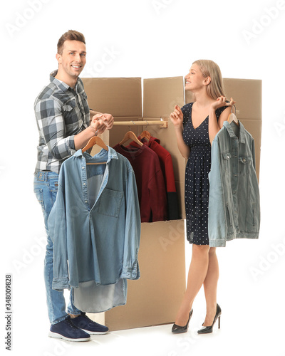 Young couple unpacking clot...