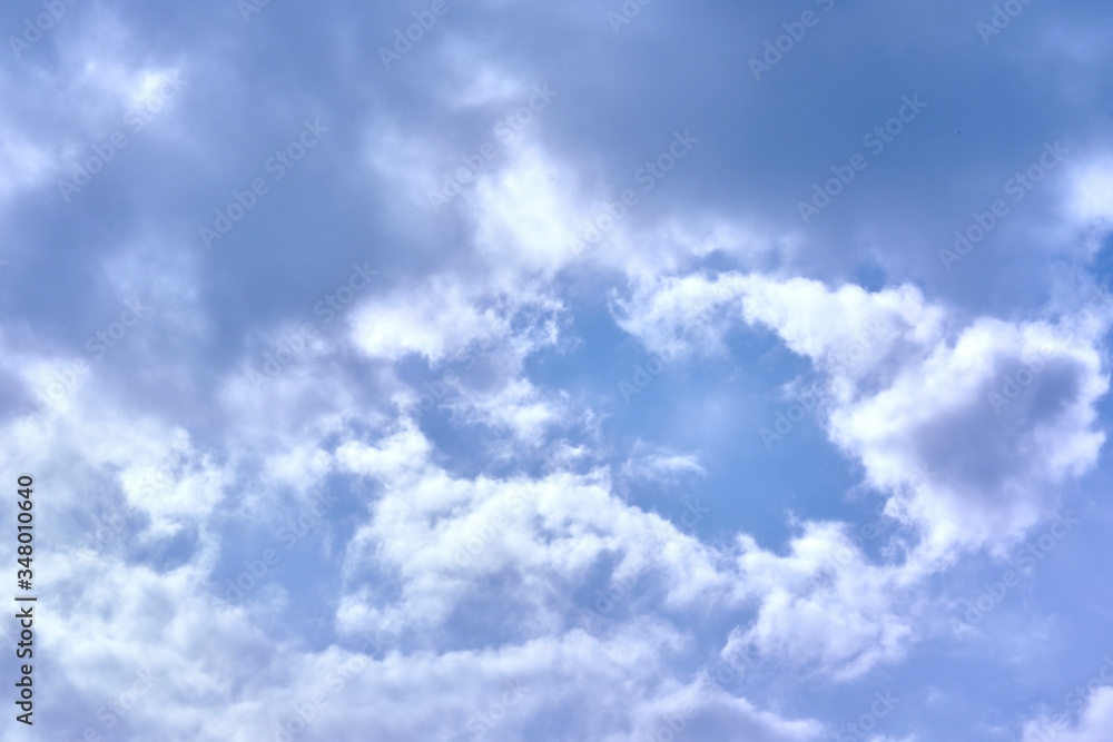 cumulus clouds with sun's lumens color sky