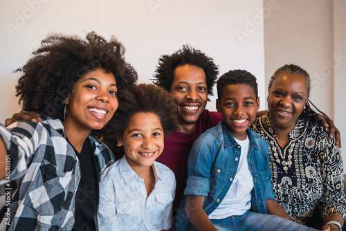 Multigenerational family taking selfie at home.