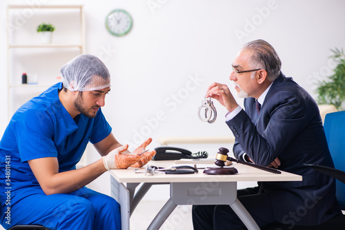 Male doctor in courthouse meeting with advocate