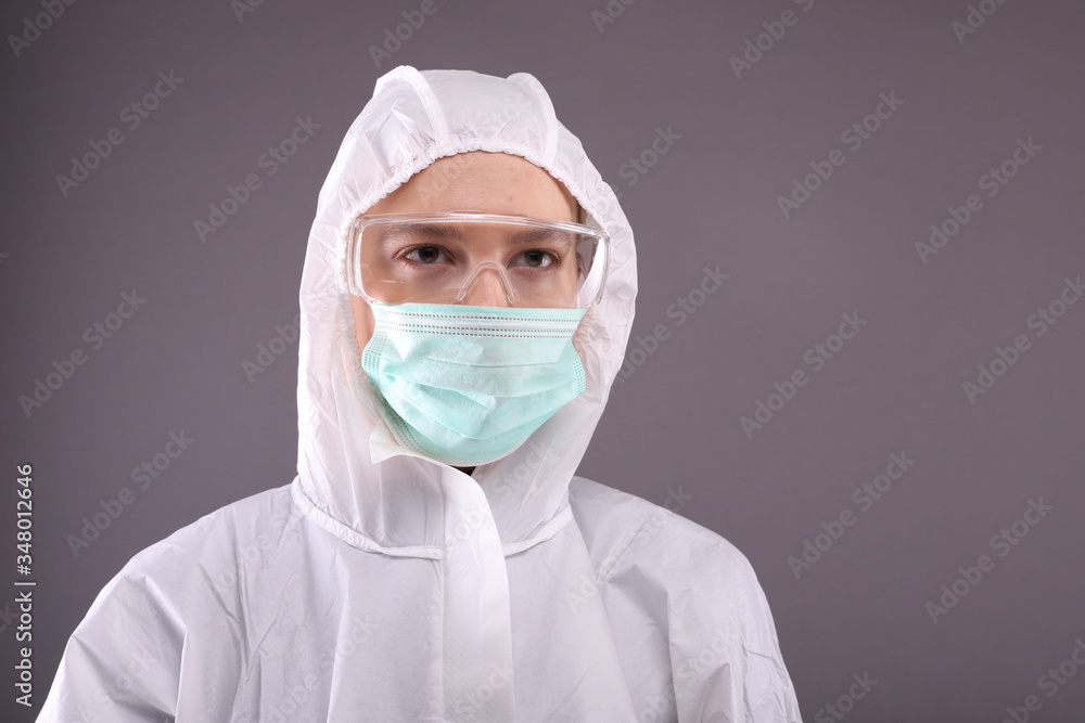 Close up of young woman in protective costume, glasses and mask Close up of young woman in protective costume, glasses and mask