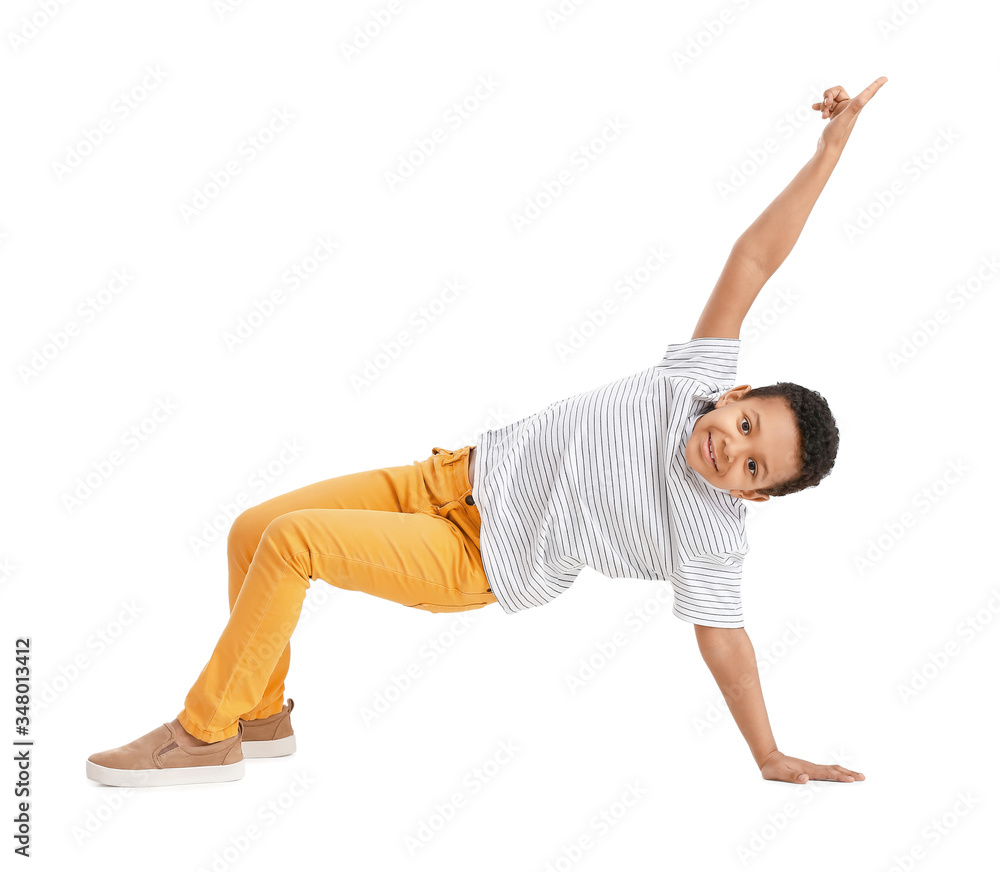 Little African-American boy dancing against white background Little African-American boy dancing against white background