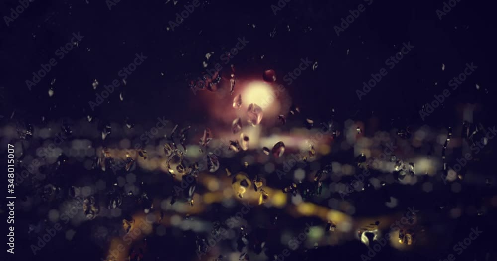 Water flowing on the glass of a tall building that has firework during New Year to be backgrounds and has an animated fire written art is number 2021. 4k video. Water flowing on the glass of a tall building that has firework during New Year to be backgrounds and has an animated fire written art is number 2021. 4k video.